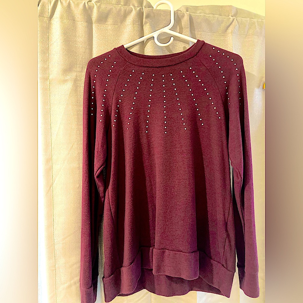 Medium size purple sweater with rhinestones.